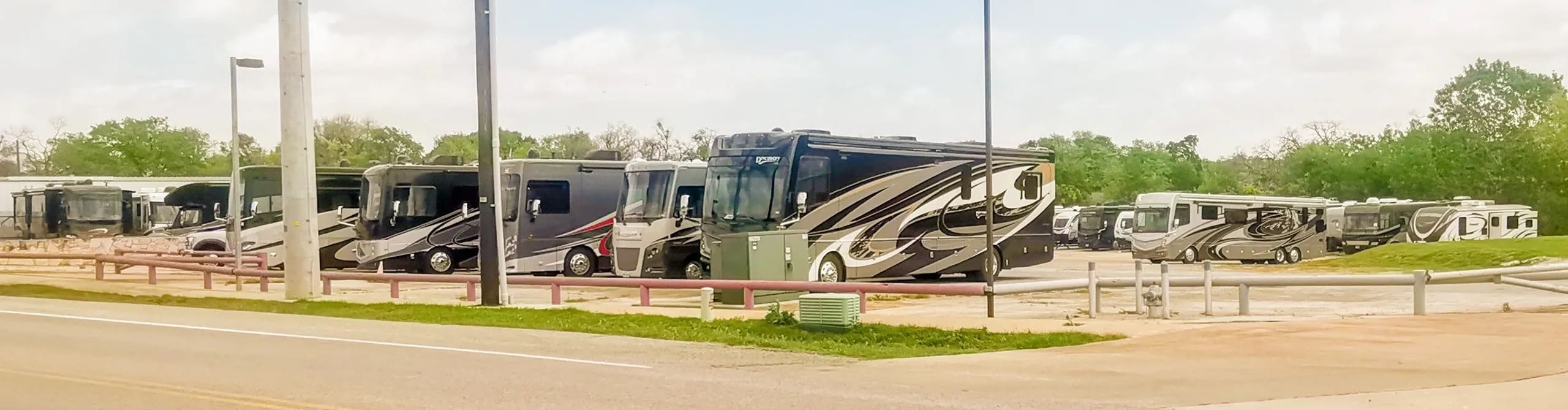 Equipment lined up across the dealership yard